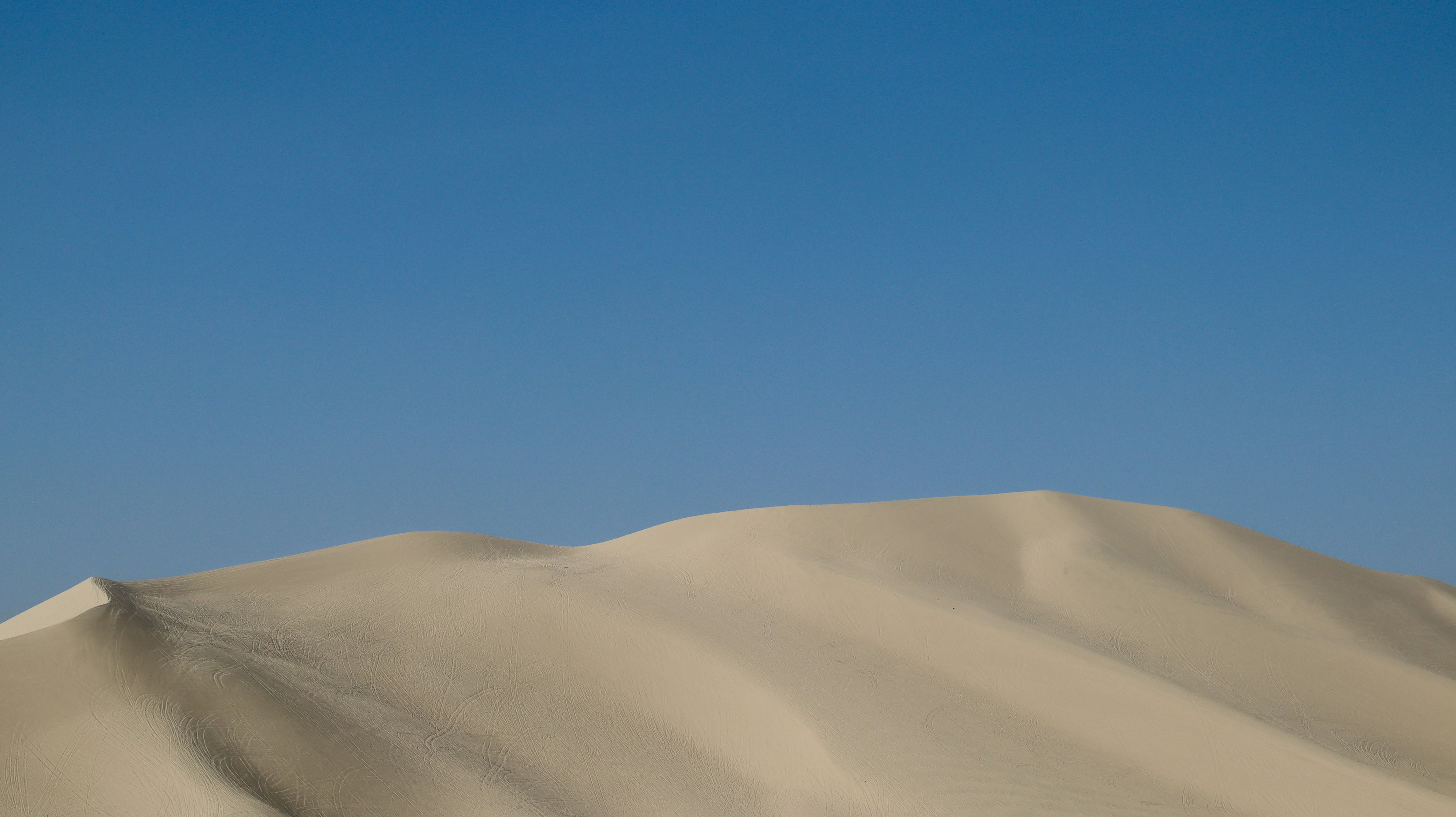 white sand under blue sky during daytime